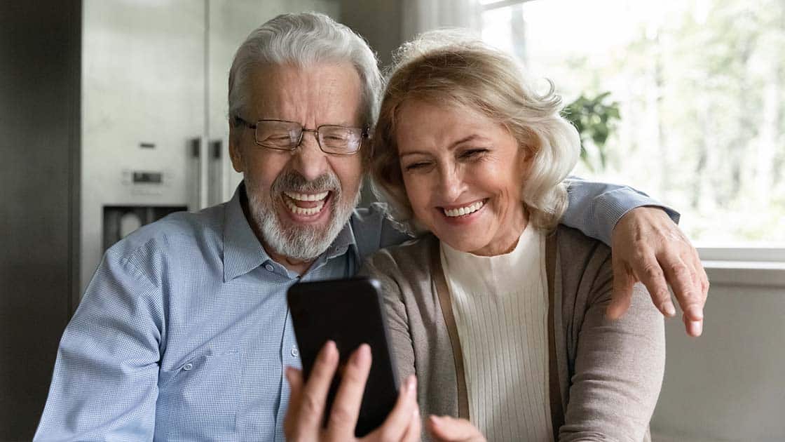 Couple Smiling At Phone