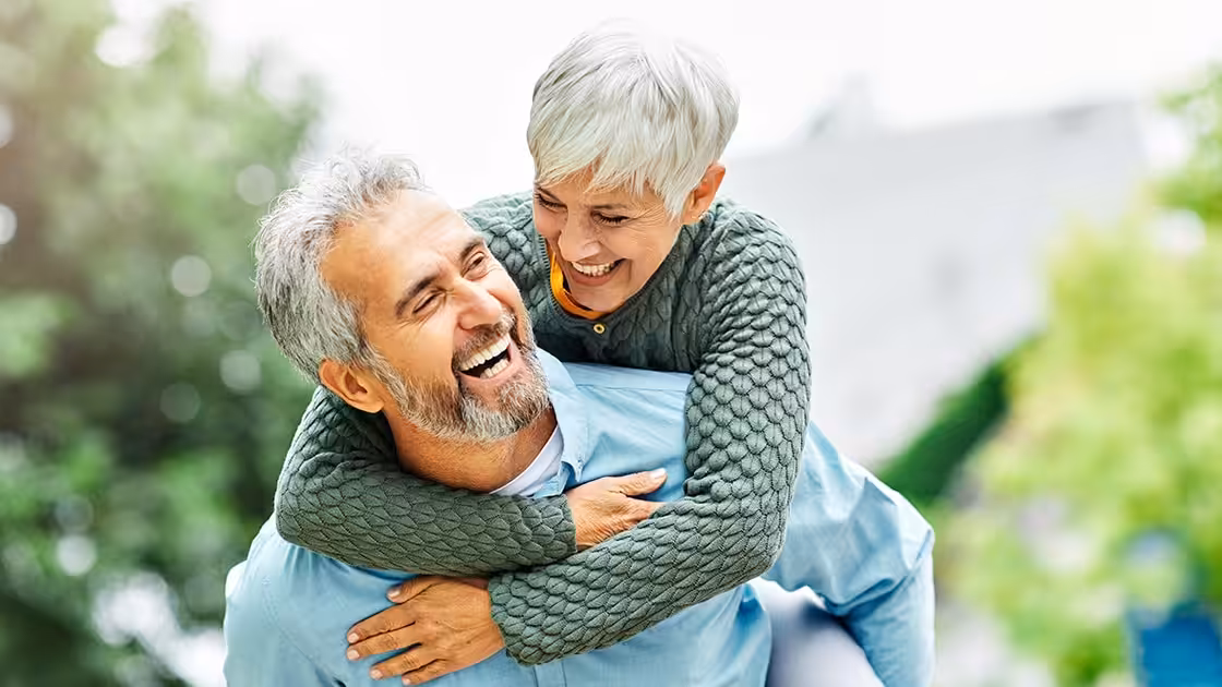 Smiling Couple In Front Of Trees - Periodontal Procedures